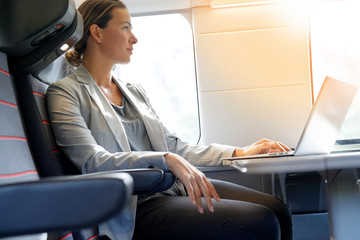 Businesswoman working in first class on a train