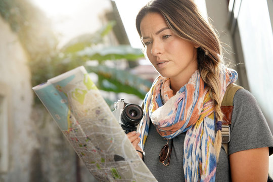 Young woman travelling looking at map