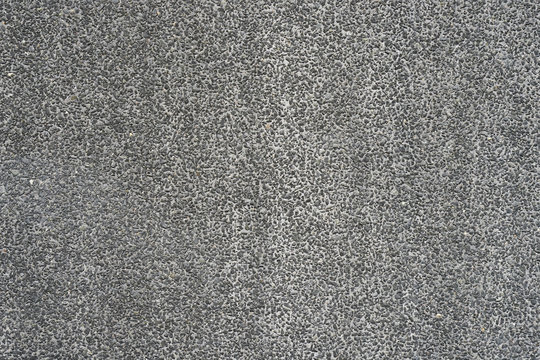 Small stones texture, road, asphalt background, gray pattern fon, wall construction, non-colored cement footage, small crumb background. Wall texture background.