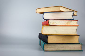 Stack of old books on gray background