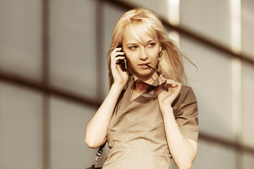 Young fashion business woman calling on cell phone