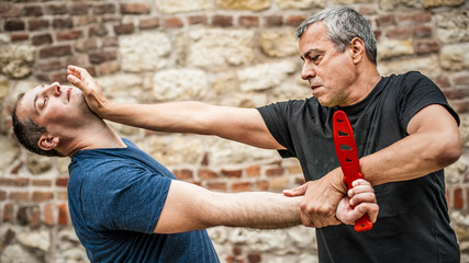 Knife disarm demonstration. Kapap instructor practice self defense knife threat disarming
