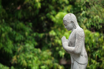 Fototapeta na wymiar Ancient statue in Candi Mendut Monastery near Borobudur. Central Java, Indonesia