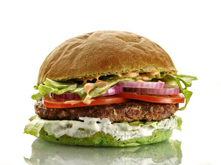 Fresh homemade delicious burger with a spinach bun. Isolated on white.
