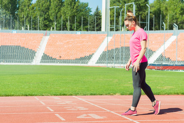 A young girl in the stadium is preparing to start.