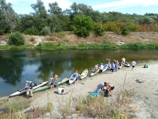 a group of young tourists going kayaking on the river.