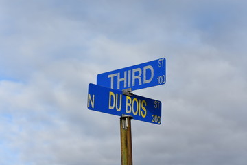 blue street sign intersection blue sky