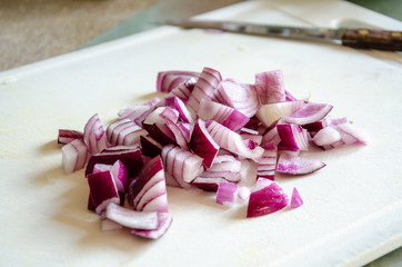 Freshly chopped red onion on a chopping board.