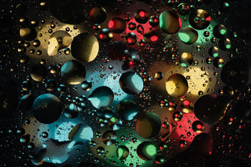 water drops on glass with colorful background, close-up 