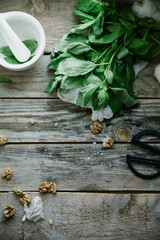 Basil pesto ingredients on wooden background. Top view composition, recipe flatlay with copy space