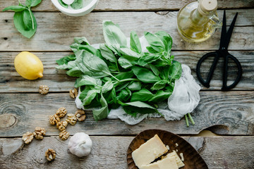 Basil pesto ingredients on wooden background. Top view composition, recipe flatlay