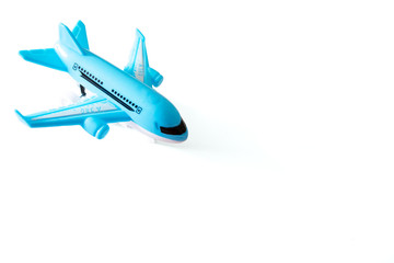 Blue toy airplane on white background with copy space, travel, journey and flying concept