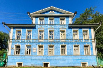 Wooden house with carved polisade in Vologda. Russian traditional architecture lies in wooden houses with manually carved decorations, often painted in white.