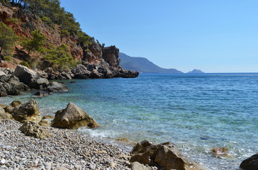 Fototapeta na wymiar sea stones in the azure waters of the Mediterranean
