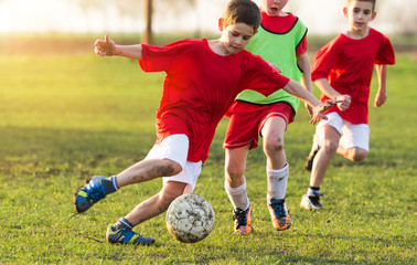 Young children players on the football match