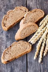 sliced bread with wheat ears on a wooden table