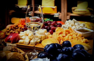 Fototapeta na wymiar Dutch cheeses and Italian wine in a cheese basement boutique.