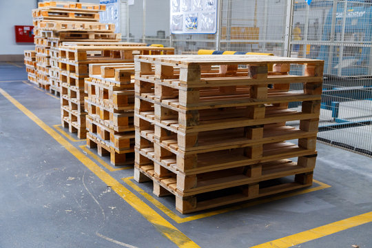 Stacked wooden pallets at a storage