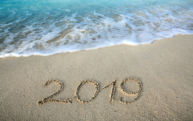 Fototapeta na wymiar New Year 2019 is coming concept on tropical beach.