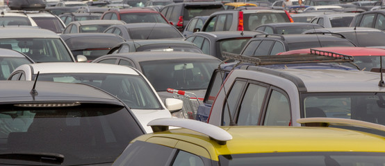 Many cars in the parking lot near the mall
