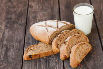 sliced bread with a glass of milk on a wooden table