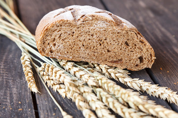 sliced bread with wheat ears on a wooden table