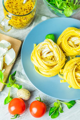 Raw homemade Italian typical pasta linguine noodles on plate