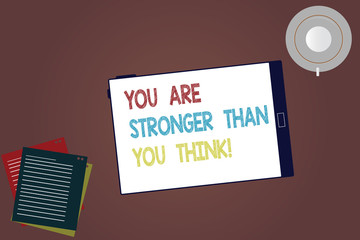 Word writing text You Are Stronger Than You Think. Business concept for Adaptability Strength to overcome obstacles Tablet Empty Screen Cup Saucer and Filler Sheets on Blank Color Background