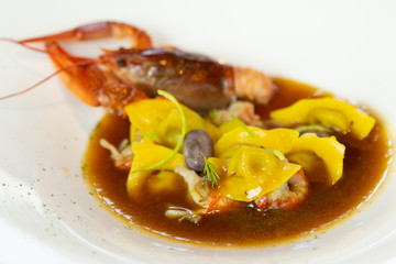 Italian tortellini hand made in fish soup with shrimps