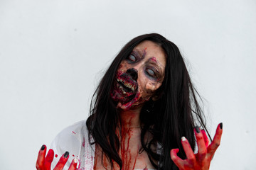 Portrait of asian woman make up ghost face with blood on white background,Horror scene,Scary...