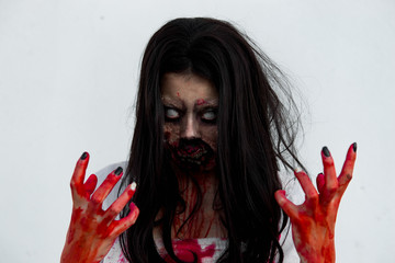 Portrait of asian woman make up ghost face with blood on white background,Horror scene,Scary...