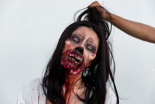 Portrait of asian woman make up ghost face with blood on white background,Horror scene,Scary background,Halloween poster,Thailand people