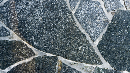 Natural stone granite background. Bright hard grey granite rock texture. Grey granite stone background