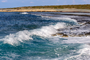 Beautiful wild beach with clear turquoise water and waves. Cyprus.