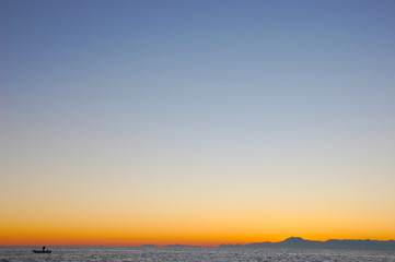 Summer, evening photo of the magnificent sky and sailor on the boat. Place for text.