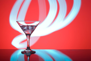 alcoholic glass in the club entourage, copy space, red background