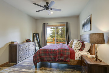 Restful country bedroom with wooden bed and dresser