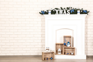 White decorated fireplace on brick wall background