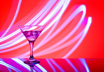 alcoholic glass in the club entourage, copy space, red background