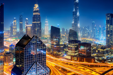 Fototapeta premium Dubai skyline at night, aerial top view to downtown city center landmarks. Famous viewpoint, United Arab Emirates