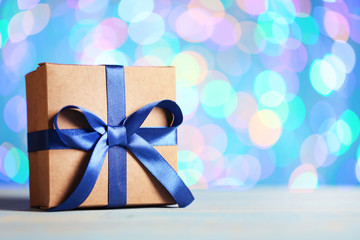 Gift box with ribbon on lights background