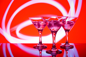 alcoholic glass in the club entourage, copy space, red background