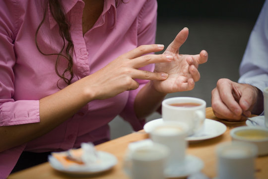 Cropped view of a woman gesturing with her fingers.