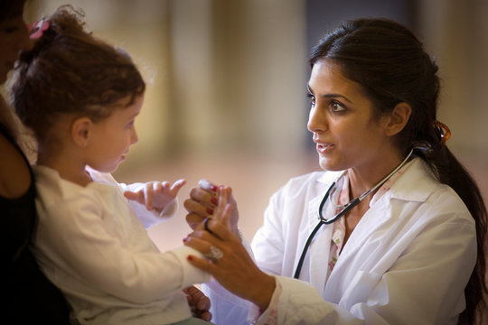 View of a doctor playing with a small girl.