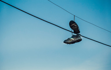 Shoes hanging on cables as spot sign of drug dealing