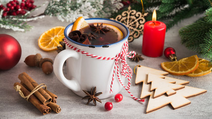 Mulled wine with spices and christmas decoration