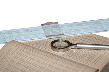 Handbook of mathematics, magnifying glass and a slide rule isolated on white background