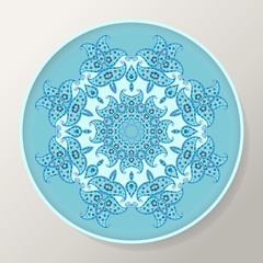 Decorative round plate with blue ornamental mandala from floral elements.