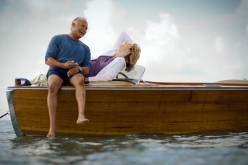 Happy mid-adult couple on a boat together on the ocean.