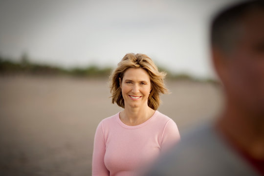 Portrait of a smiling mid-adult woman on a beach.